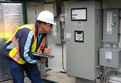 man looking at electric meter